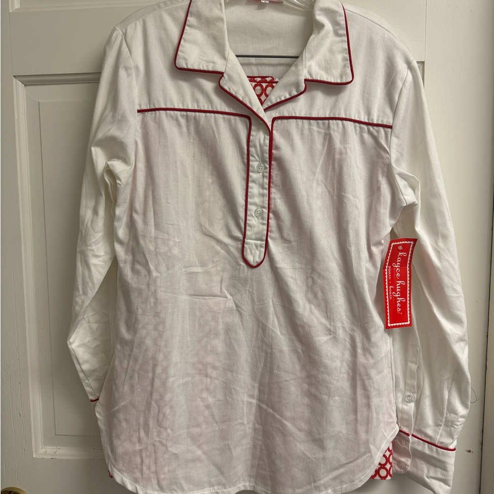 Kayce Hughes white popover shirt with red piping.